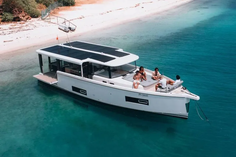 The Image of Manufacturer Provided Image: 2026 Jeanneau Sea Loft 480 anchored near a beach, with people relaxing on deck. - 0