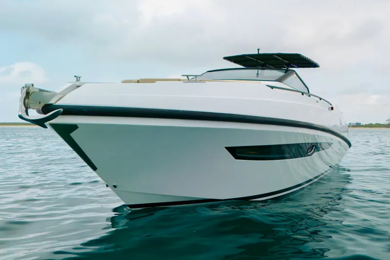 The Image of 2023 Rio Yachts Daytona 34 cruising on calm waters under a cloudy sky. - 0