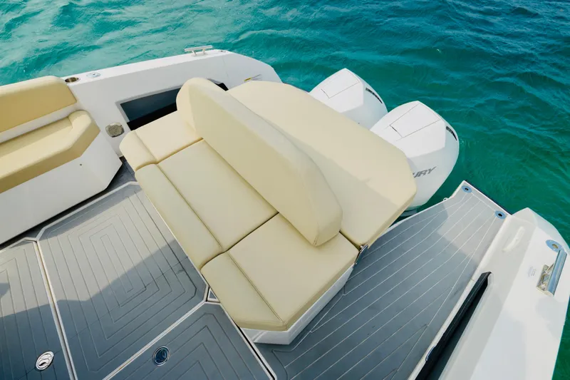 Slide: The Image of 2023 Rio Yachts Daytona 34 with beige seating and dual Mercury outboard engines on blue water. - 10