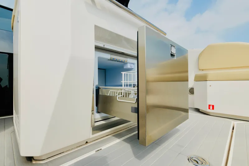 Slide: The Image of 2023 Rio Yachts Daytona 34, open stainless steel drawer on deck, modern design. - 18