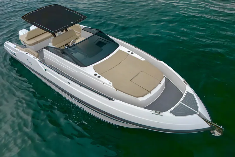 Slide: The Image of 2023 Rio Yachts Daytona 34, sleek design, cruising on clear water. - 2