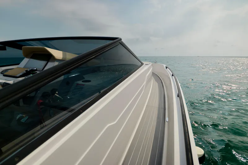 Slide: The Image of 2023 Rio Yachts Daytona 34 cruising on open water under a clear sky. - 26