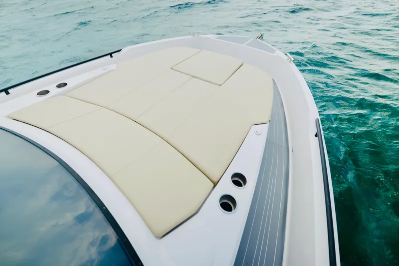 Slide: The Image of 2023 Rio Yachts Daytona 34 bow with sunpad, cruising on clear blue water. - 29