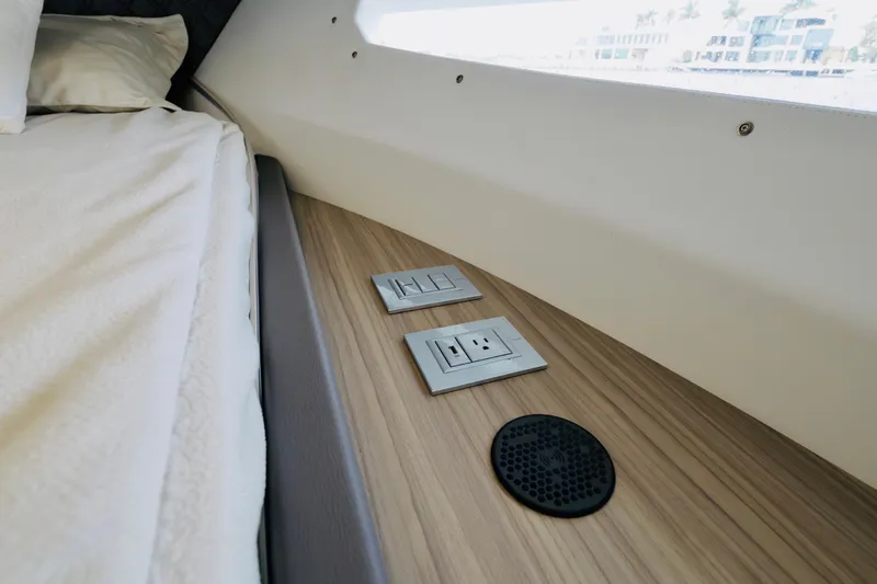 Slide: The Image of 2023 Rio Yachts Daytona 34 interior with outlets and speaker on wood panel. - 36