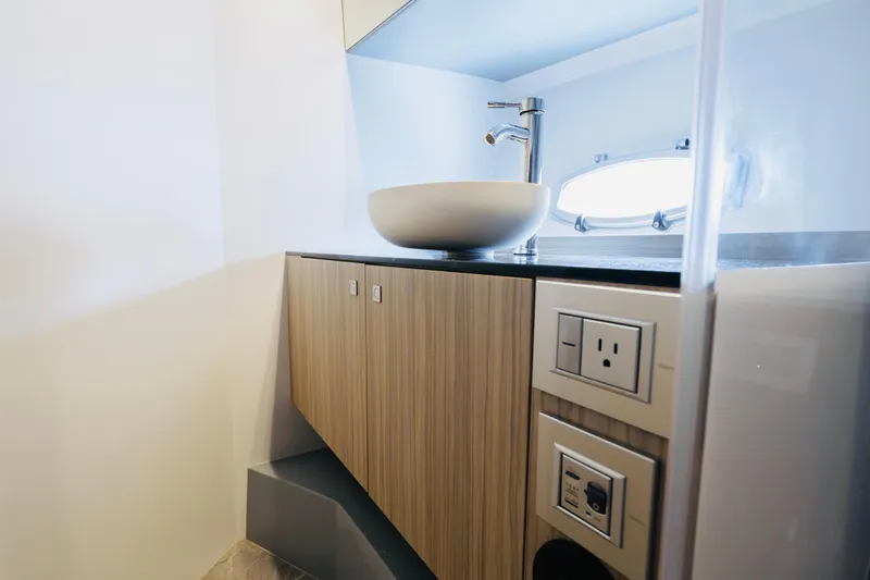 Slide: The Image of Modern bathroom interior of 2023 Rio Yachts Daytona 34 with sleek sink and wooden cabinetry. - 41