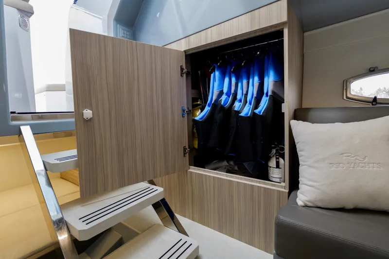 Slide: The Image of Interior of 2023 Rio Yachts Daytona 34, featuring wetsuit storage and seating area. - 43