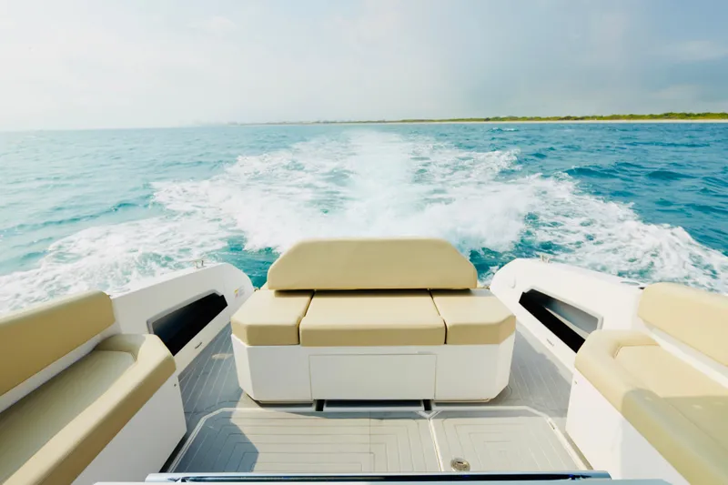Slide: The Image of 2023 Rio Yachts Daytona 34 cruising on open water, showcasing luxurious seating and wake trail. - 8