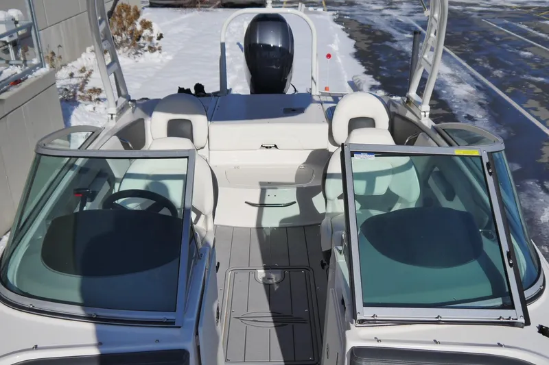 Slide: The Image of 2023 Chaparral 21 SSi Ski & Fish OB boat interior with dual consoles and seating. - 12
