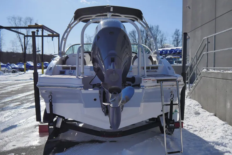 Slide: The Image of 2023 Chaparral 21 SSi Ski & Fish OB boat, rear view in snowy outdoor setting. - 2