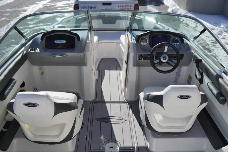 Slide: The Image of 2023 Chaparral 21 SSi Ski & Fish OB boat interior with dual seats and steering console. - 7