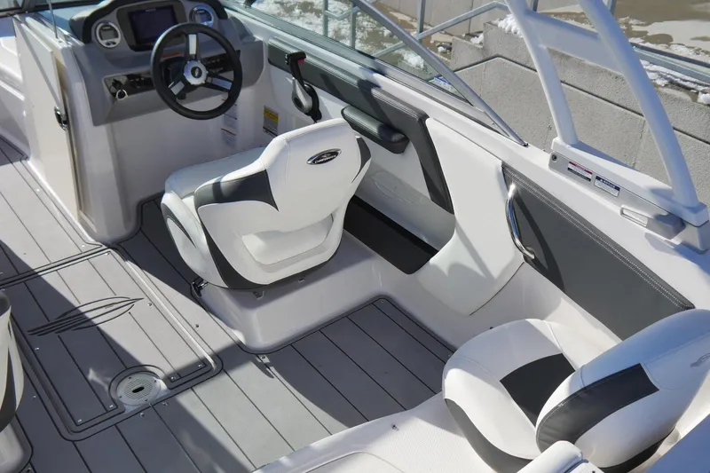 Slide: The Image of 2023 Chaparral 21 SSi Ski & Fish OB interior with modern seating and dashboard. - 8