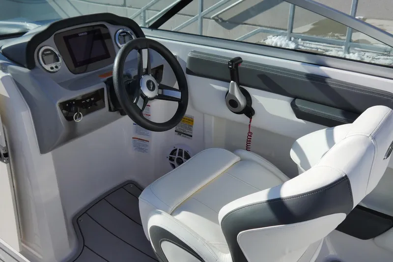 Slide: The Image of 2023 Chaparral 21 SSi Ski & Fish OB boat cockpit with steering wheel and controls. - 9