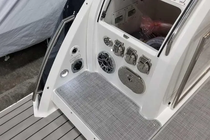 Slide: The Image of 2023 Formula 380 Super Sport Crossover OB boat deck with control panel and storage. - 11