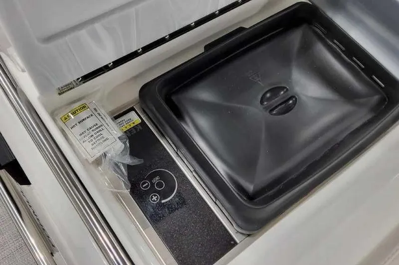 Slide: The Image of 2023 Formula 380 Super Sport Crossover OB boat interior with control panel and storage compartment. - 16