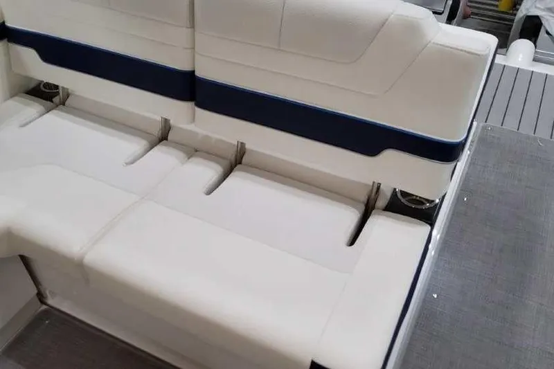 Slide: The Image of 2023 Formula 380 Super Sport Crossover OB boat seating, featuring white and blue upholstery. - 18