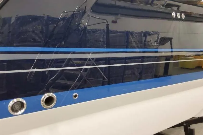 Slide: The Image of 2023 Formula 380 Super Sport Crossover OB boat with sleek blue and white design. - 2