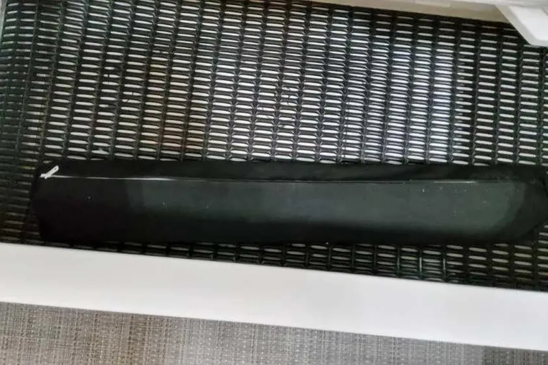 Slide: The Image of Black object on a mesh surface, possibly part of a 2023 Formula 380 Super Sport Crossover OB. - 23