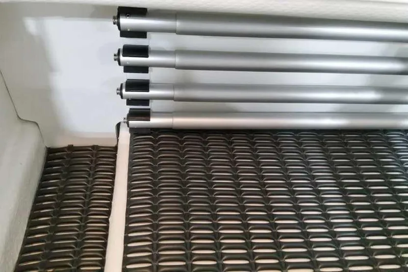 Slide: The Image of Storage compartment with metal rods in a 2023 Formula 380 Super Sport Crossover OB boat. - 26