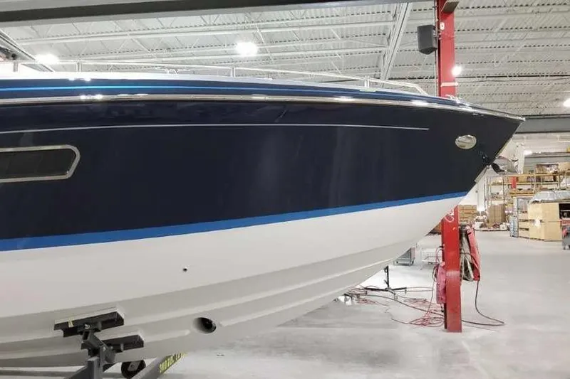 Slide: The Image of 2023 Formula 380 Super Sport Crossover OB boat in a showroom. - 3