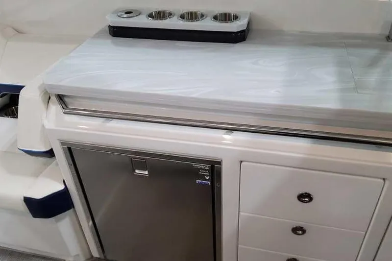 Slide: The Image of 2023 Formula 380 Super Sport Crossover OB interior with fridge and storage drawers. - 30