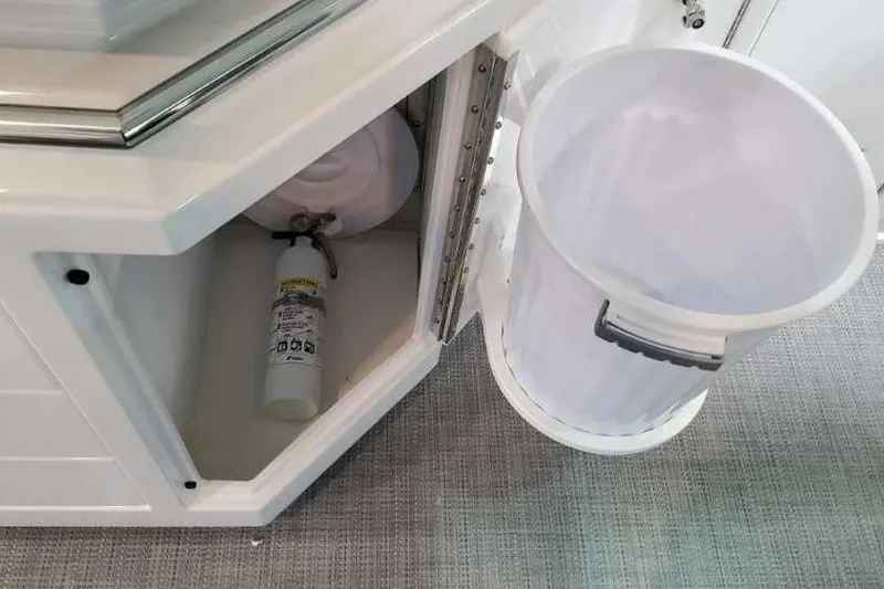 Slide: The Image of 2023 Formula 380 Super Sport Crossover OB interior storage with fire extinguisher and trash bin. - 34