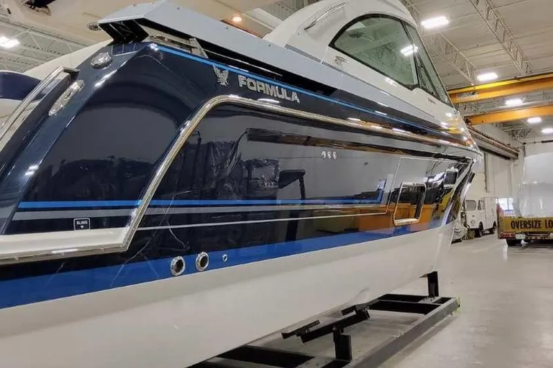 Slide: The Image of 2023 Formula 380 Super Sport Crossover OB boat in a showroom. - 4