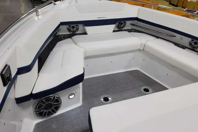 Slide: The Image of 2023 Formula 380 Super Sport Crossover OB boat interior with white seating and speakers. - 43