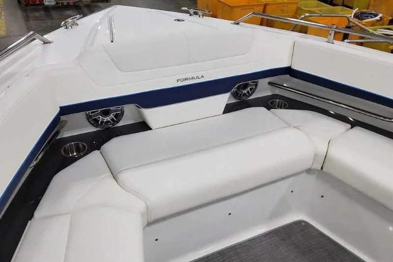 Slide: The Image of 2023 Formula 380 Super Sport Crossover OB boat interior with white seating and speakers. - 44