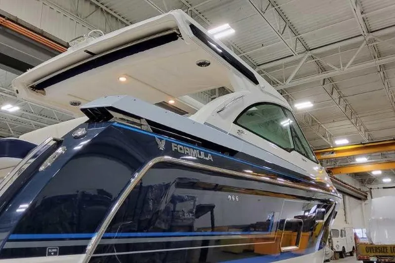 Slide: The Image of 2023 Formula 380 Super Sport Crossover OB in a showroom, showcasing sleek design. - 5