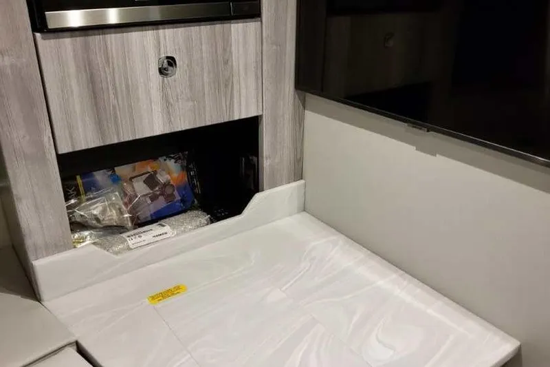 Slide: The Image of Interior of 2023 Formula 380 Super Sport Crossover OB, featuring modern cabinetry. - 64