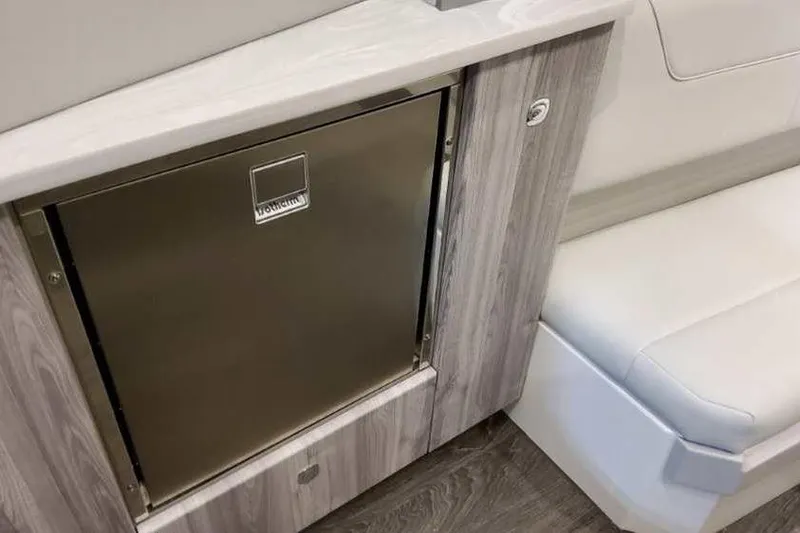 Slide: The Image of 2023 Formula 380 Super Sport Crossover OB interior with stainless steel fridge and white seating. - 67