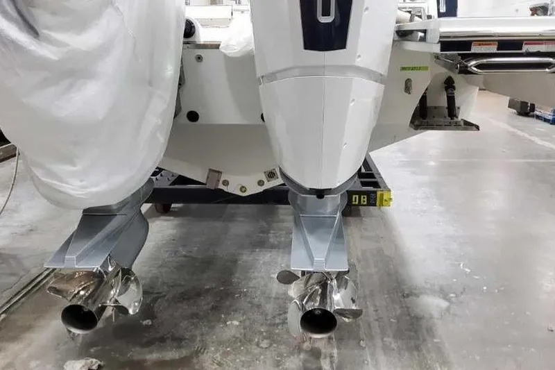 Slide: The Image of 2023 Formula 380 Super Sport Crossover OB boat engines in a workshop setting. - 7