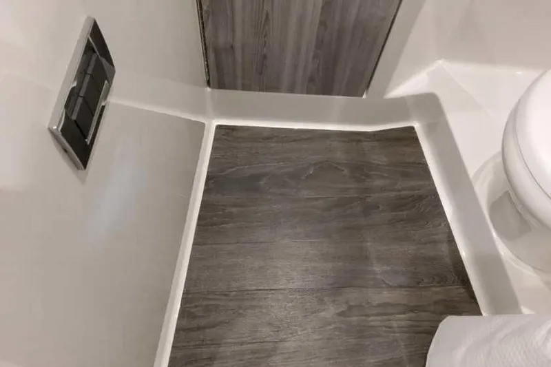 Slide: The Image of 2023 Formula 380 Super Sport Crossover OB bathroom with wood-style flooring and modern fixtures. - 78