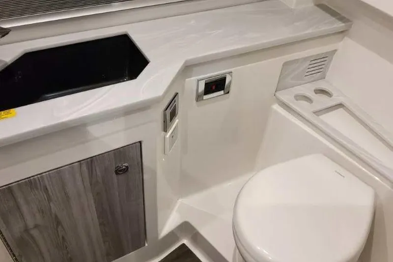 Slide: The Image of 2023 Formula 380 Super Sport Crossover OB bathroom with modern sink and toilet design. - 79