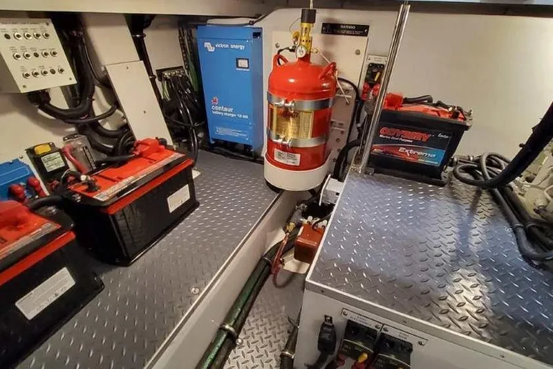 Slide: The Image of Engine room of 2023 Formula 380 Super Sport Crossover OB with batteries and fire extinguisher. - 86