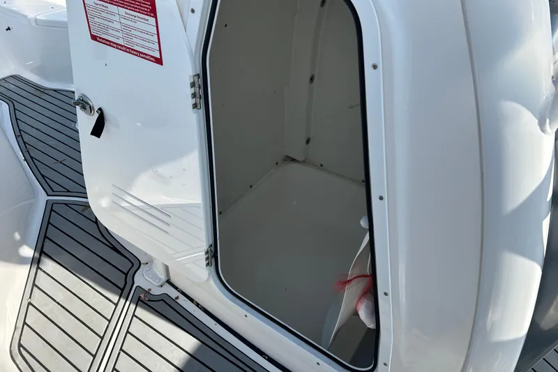 Slide: The Image of Open storage compartment on 2020 Tidewater 232 LXF boat, featuring sleek white interior. - 13