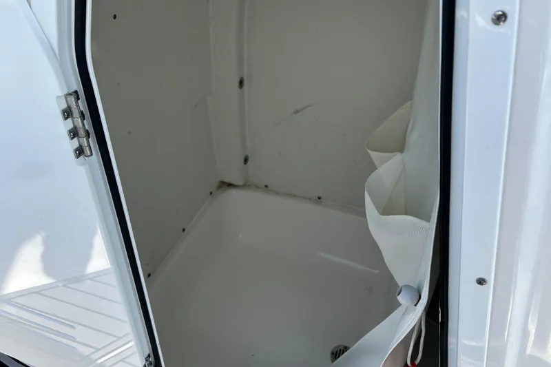 Slide: The Image of 2020 Tidewater 232 LXF boat storage compartment with open door. - 14