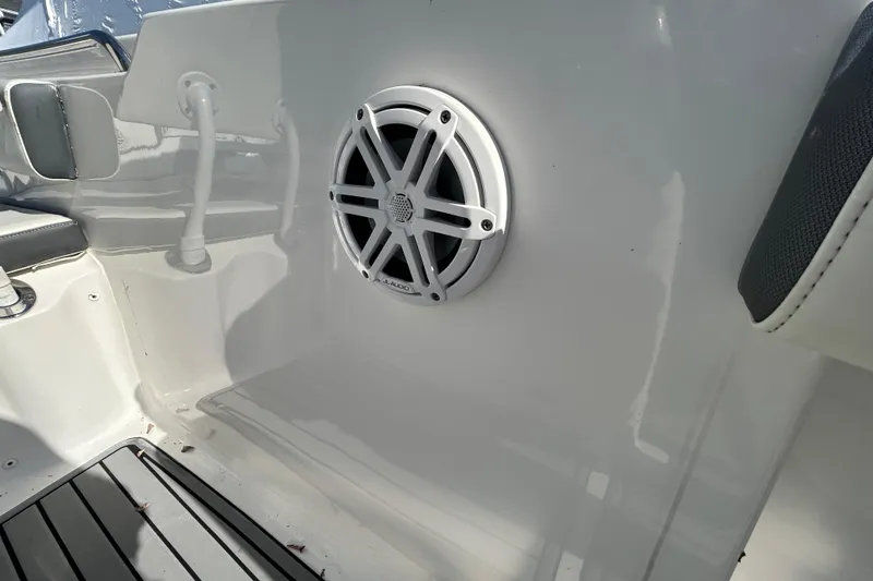 Slide: The Image of 2020 Tidewater 232 LXF boat interior with speaker and seating detail. - 21