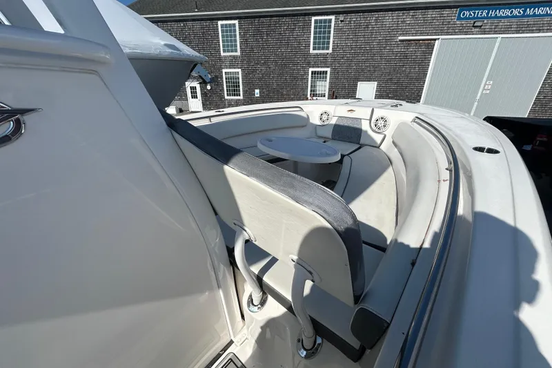 Slide: The Image of 2020 Tidewater 232 LXF boat interior with seating and table, docked at marina. - 22