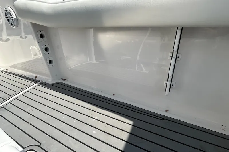 Slide: The Image of 2020 Tidewater 232 LXF boat interior with cushioned seating and sleek flooring. - 26