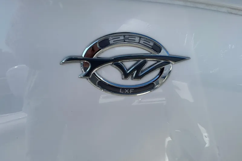 Slide: The Image of Chrome emblem of 2020 Tidewater 232 LXF boat on white surface. - 33