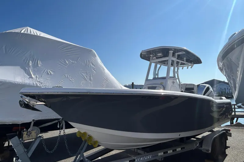 Slide: The Image of 2020 Tidewater 232 LXF boat on trailer under clear blue sky. - 35