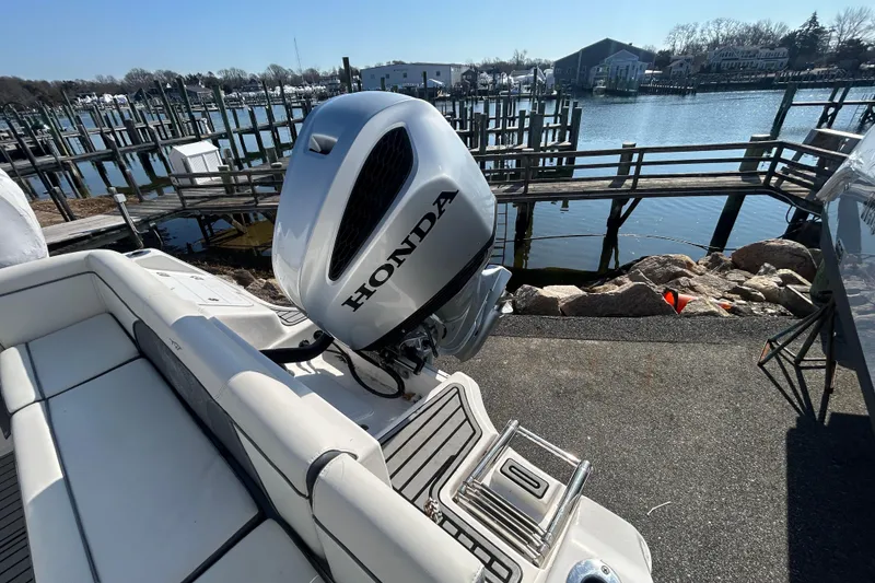 Slide: The Image of 2020 Tidewater 232 LXF boat with Honda outboard motor docked by the waterfront. - 4