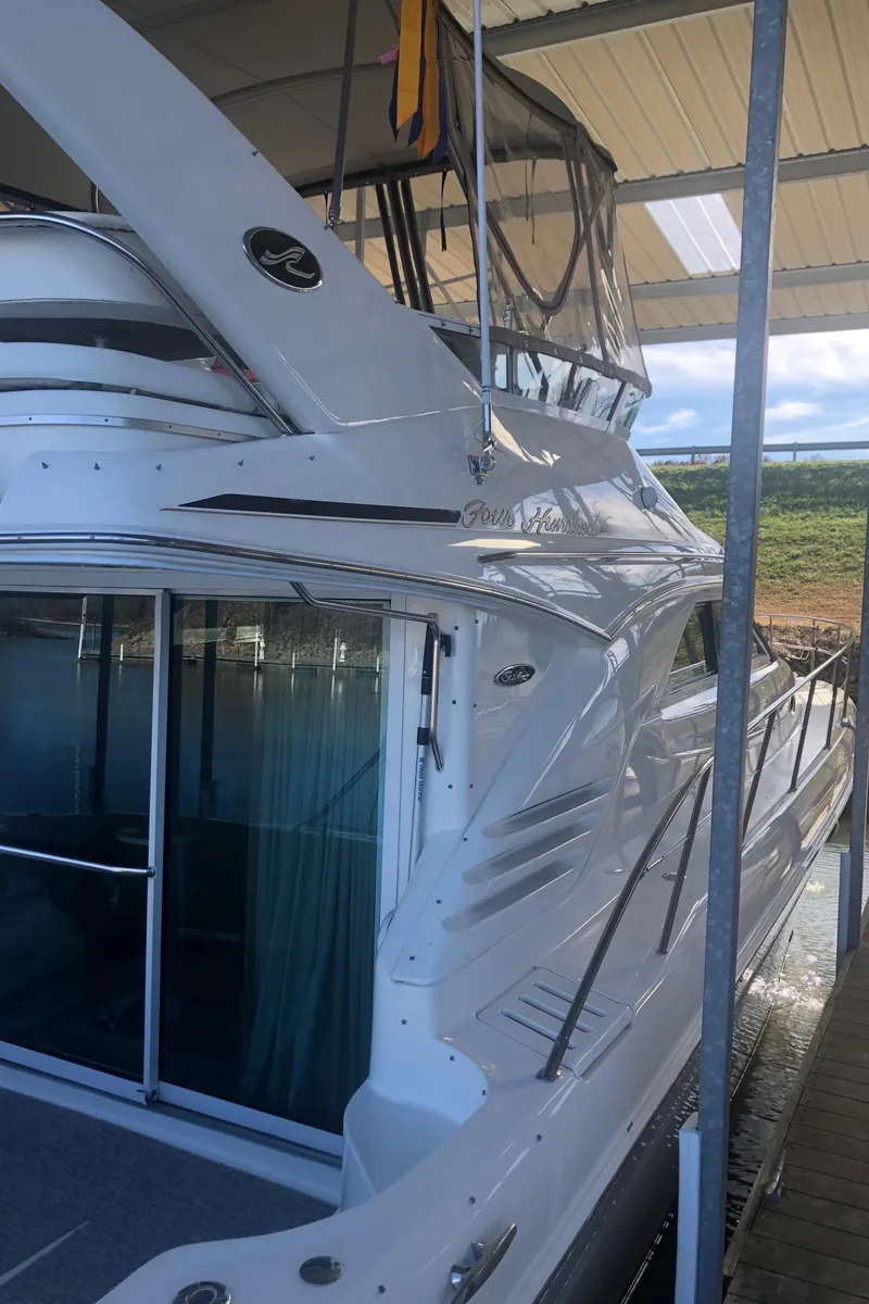 Slide: The Image of 2001 Sea Ray 400 Sedan Bridge yacht docked under a covered marina. - 4