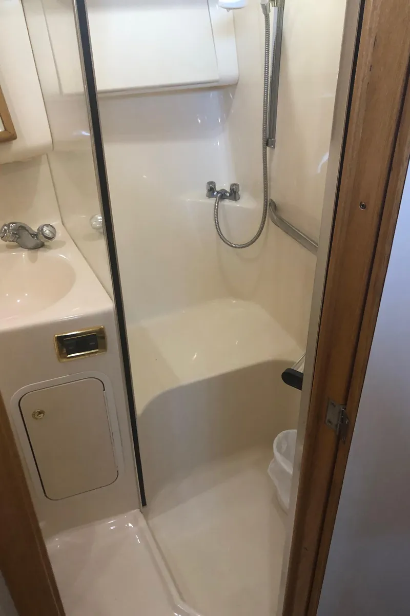 Slide: The Image of 2001 Sea Ray 400 Sedan Bridge bathroom with shower and sink. - 42