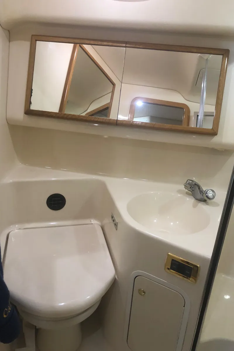 Slide: The Image of 2001 Sea Ray 400 Sedan Bridge bathroom with sink, mirror, and toilet. - 43