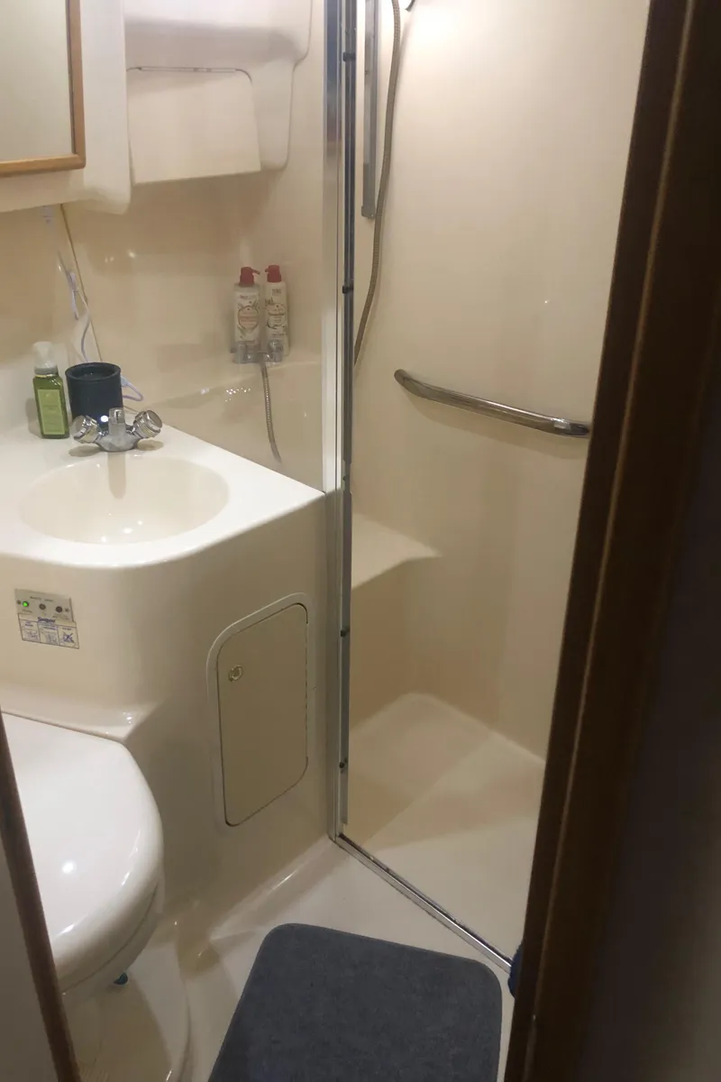 Slide: The Image of Bathroom interior of 2001 Sea Ray 400 Sedan Bridge yacht, featuring shower and sink. - 48