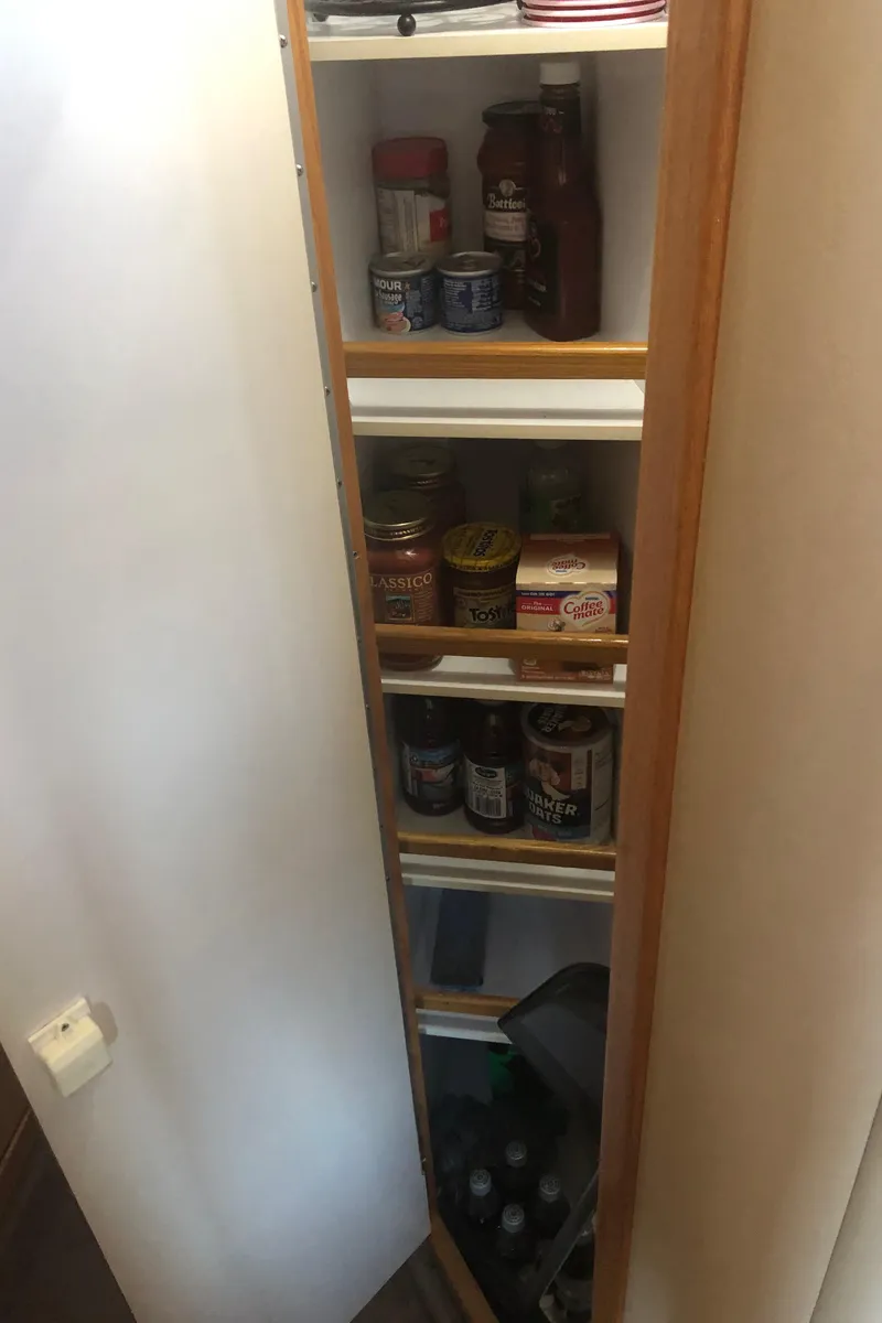 Slide: The Image of Pantry shelves on a 2001 Sea Ray 400 Sedan Bridge yacht. - 49