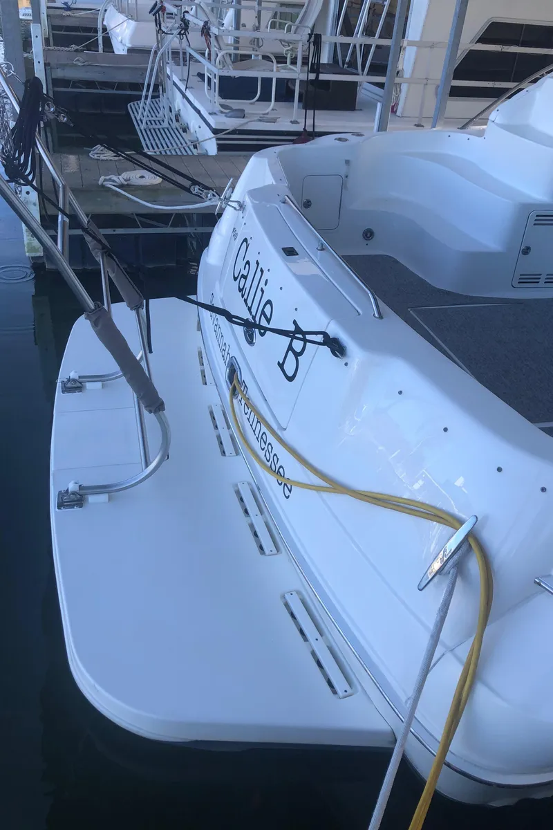 Slide: The Image of 2001 Sea Ray 400 Sedan Bridge docked, rear view with "Callie B" name visible. - 5