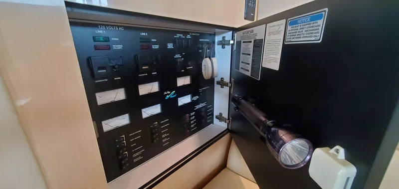 Slide: The Image of Electrical panel inside 2001 Sea Ray 400 Sedan Bridge yacht with flashlight. - 52